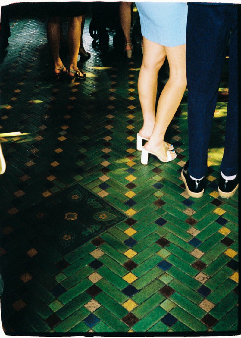 35mm photo of wedding guests with a green tiled floor