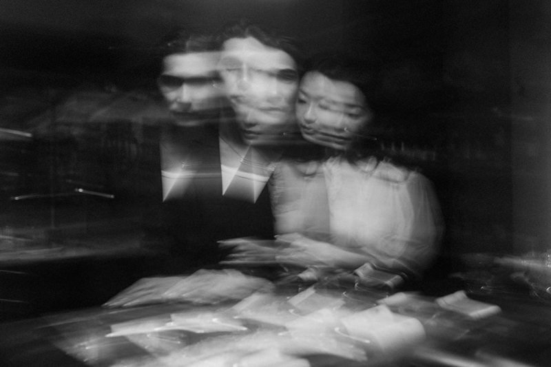 blurry multiple exposure photo of newly engaged couple inside a restaurant