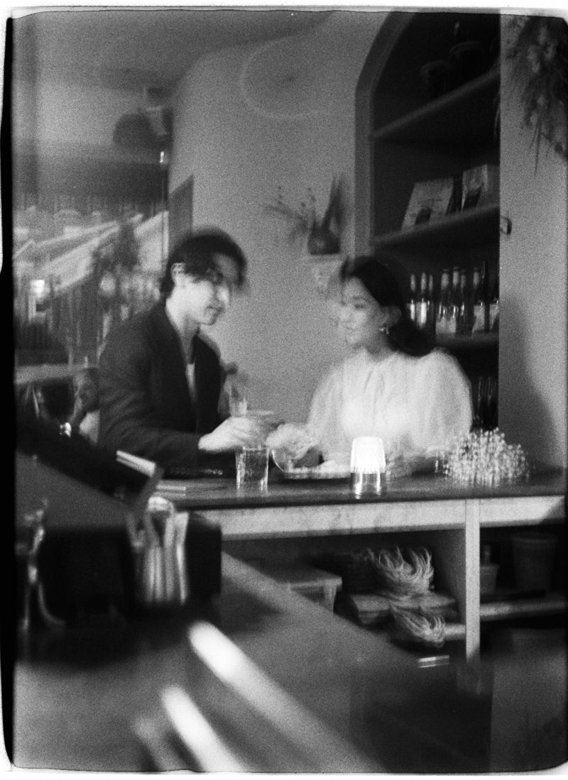 engaged couple photographed on 35mm film in a restaurant in vancouver