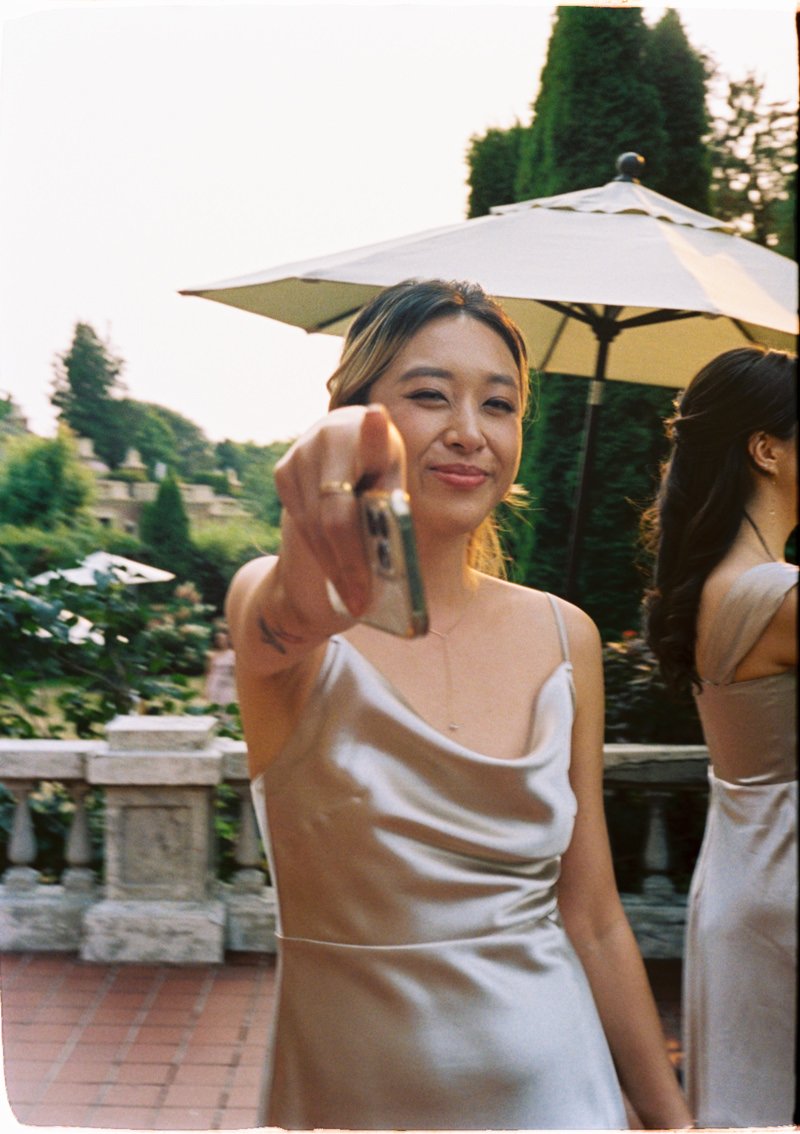 bridesmaid playfully pointing towards the camera