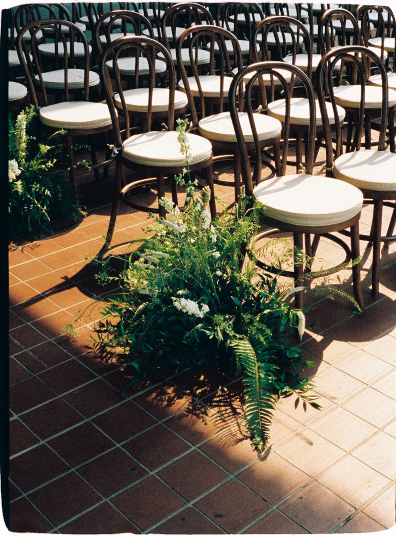 film photo of rustic fern arrangement at wedding ceremony