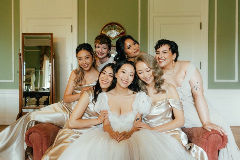 casual photo of bride and her bridemaids wearing champagne coloured dresses