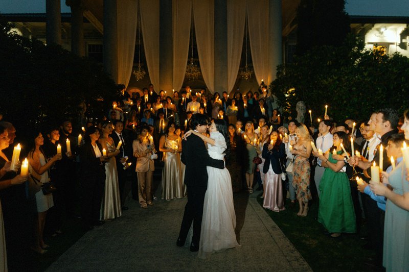 wedding guests holding candles during first dance