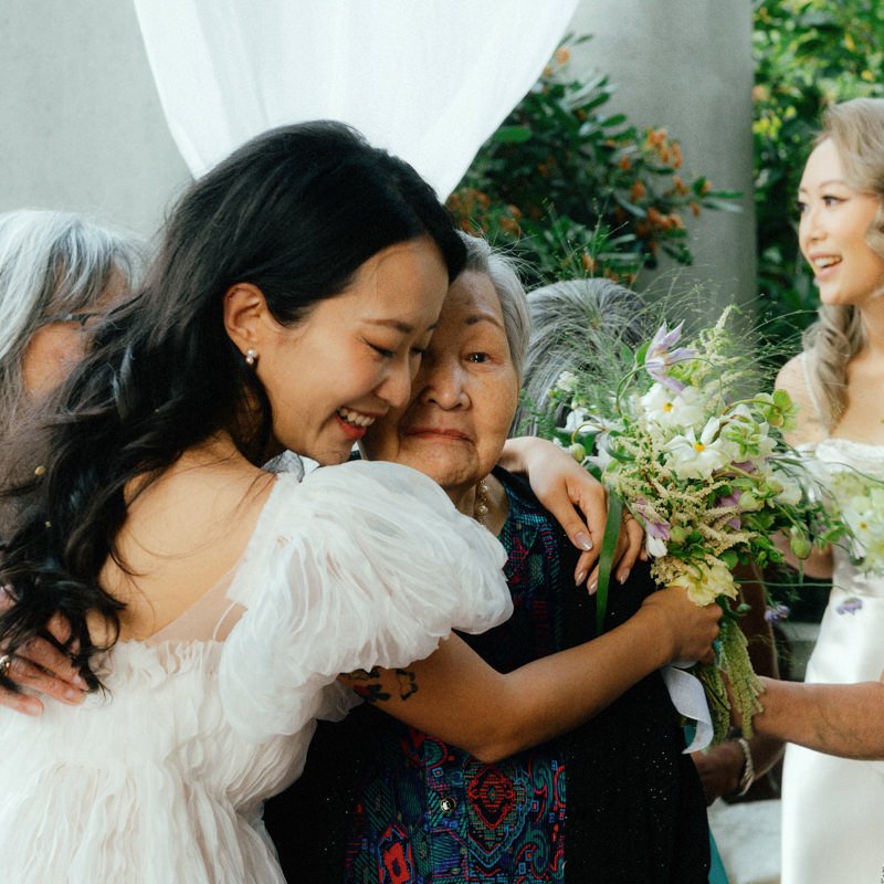 bride hugging teary eyed grandmother