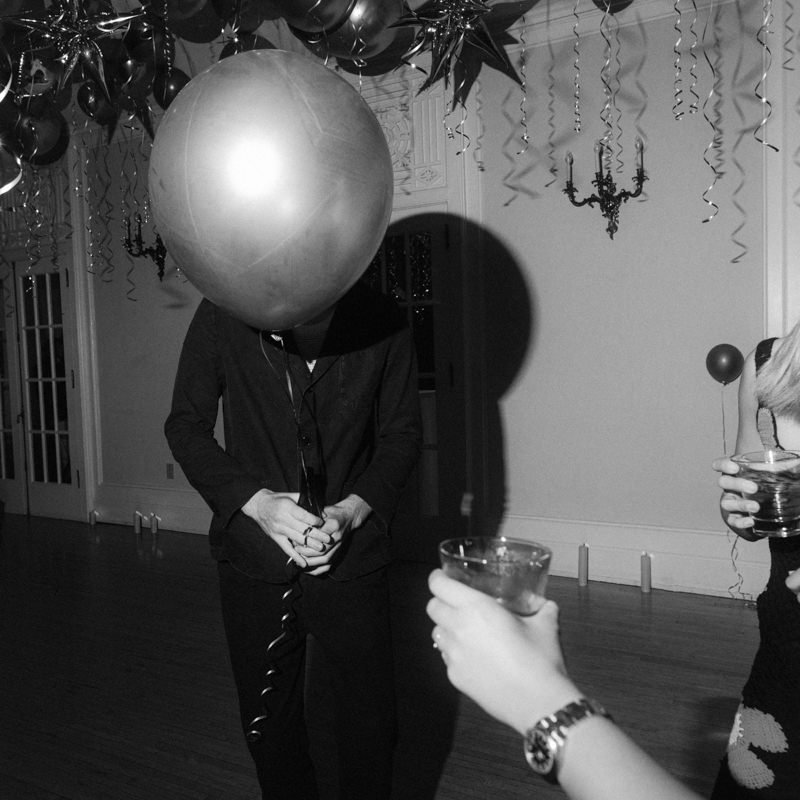 balloon comically obscuring guest face