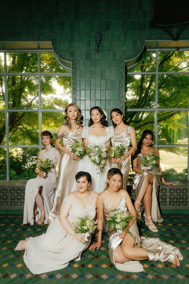 bride and her party posing in a green tiled room at hycroft manor
