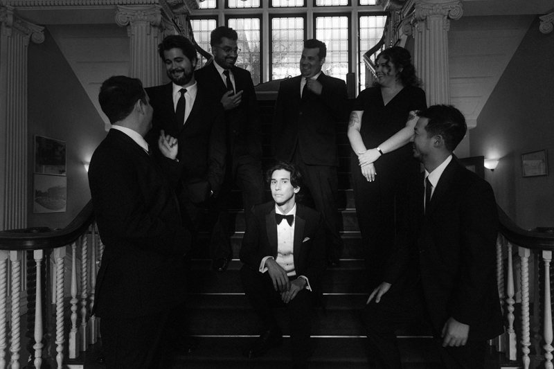 unique portrait of groom surrounded by his party