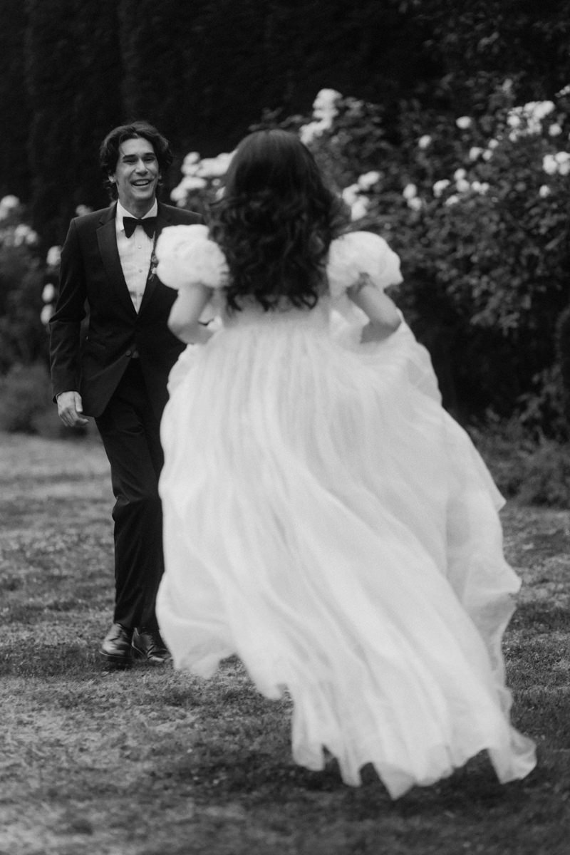 happy bride running towards smiling groom during the first look