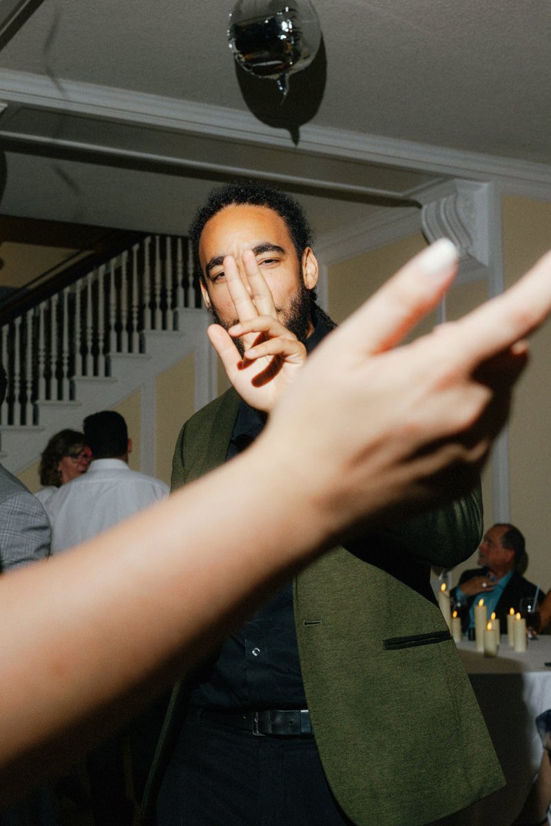 wedding guest displaying a peace sign