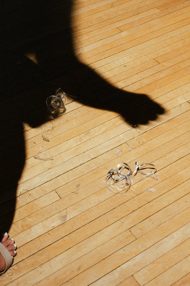 broken wine glass and silhouette of a hand