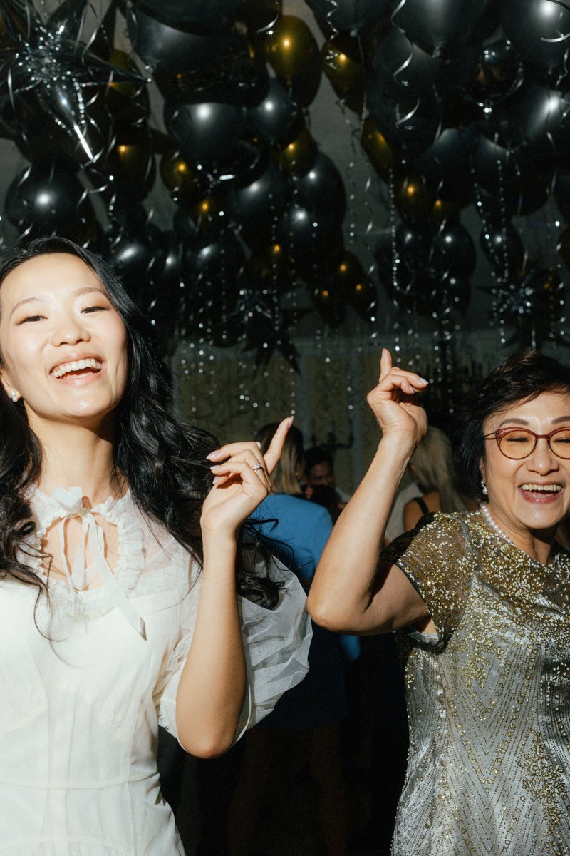 bride and mother dancing during the party