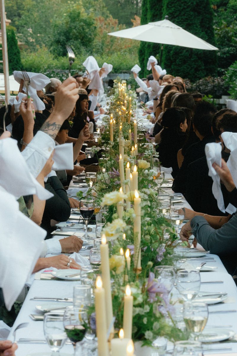 wedding guests waving napkins and forks