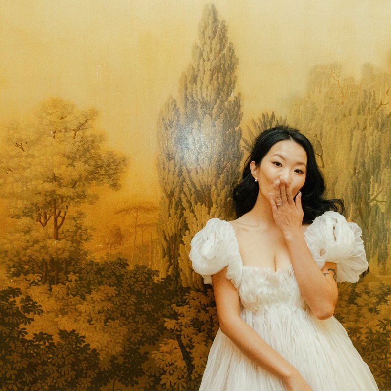 bride wearing danielle frankel and blowing a kiss towards the camera