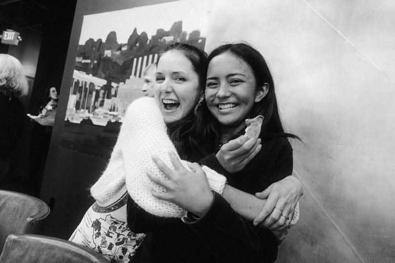 wedding guests hugging each other during a welcome reception event in Seattle