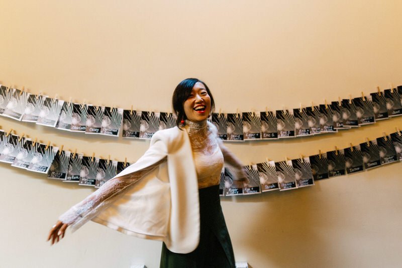 stylish wedding guest showing off her white lace cape