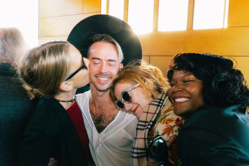 wedding guests kissing and hugging each other during cocktail hour at Withinsodo Seattle