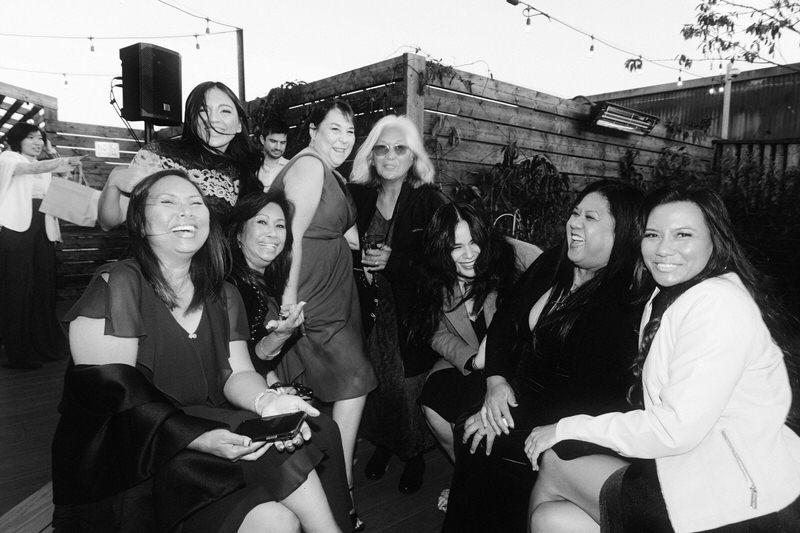 large group of wedding guests posing for the camera during cocktail hour at Withinsodo Seattle