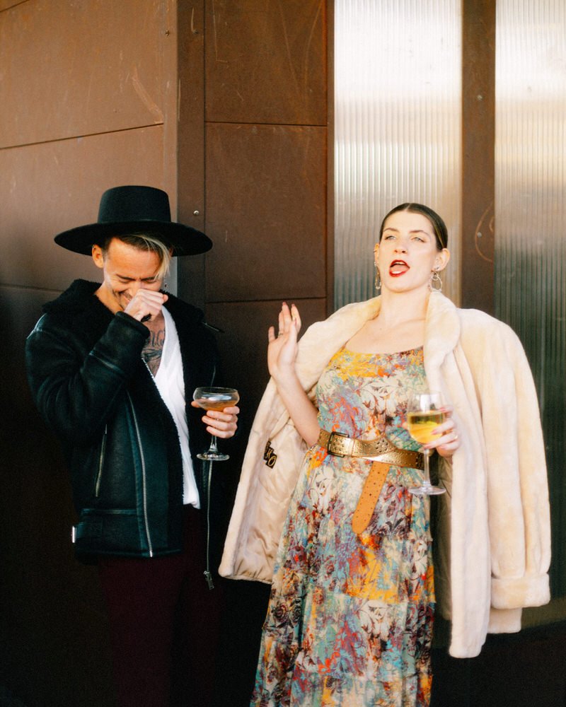 fashionable wedding guests enjoying wine during cocktail hour at Withinsodo Seattle