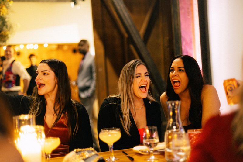 wedding guests laughing during speeches spoken at a wedding reception in Seattle