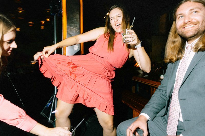 guest showing off her dress after she spilled her drink on it