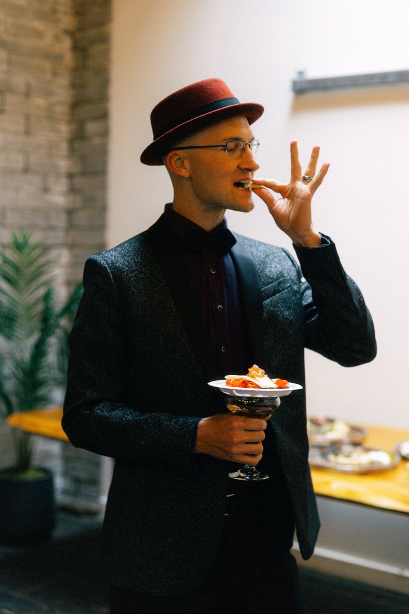 stylish male wedding guest enjoying appetizers during cocktail hour at Withinsodo Seattle