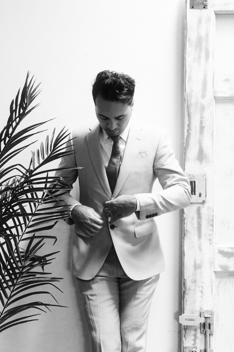 groom in light colored suit waiting for guests to arrive at Withinsodo Seattle