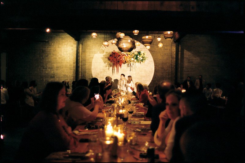 wedding couple speaking to guests during dinner reception at Withinsodo Seattle