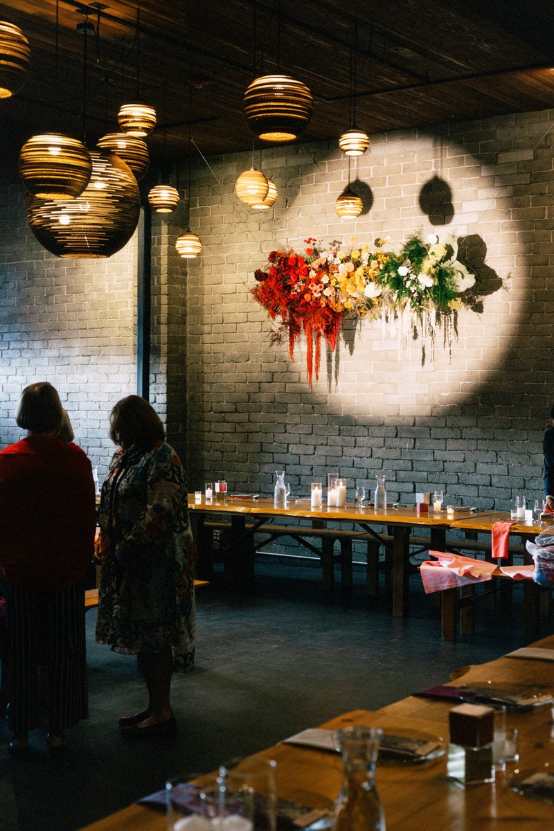 rainbow colored hanging floral installation designed by Kinetic Botany Seattle