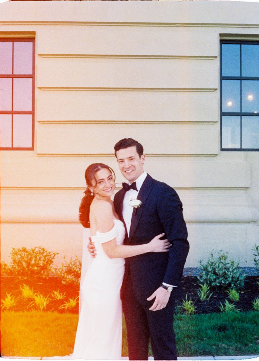 35mm film photo of bride and groom outside the Switch House by Cescaphe in Philadelphia. the photo has an interesting light leak