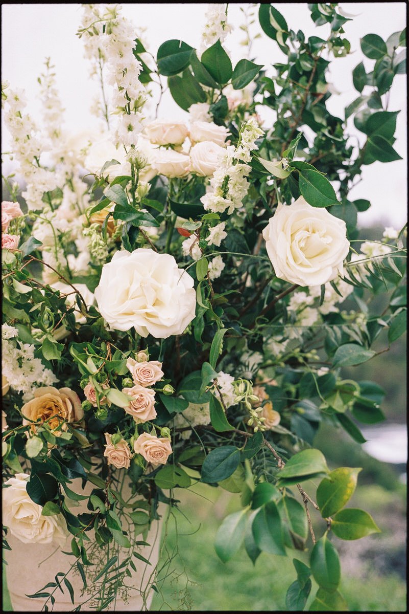 35mm film photo of a large floral arrangement using different coloured roses