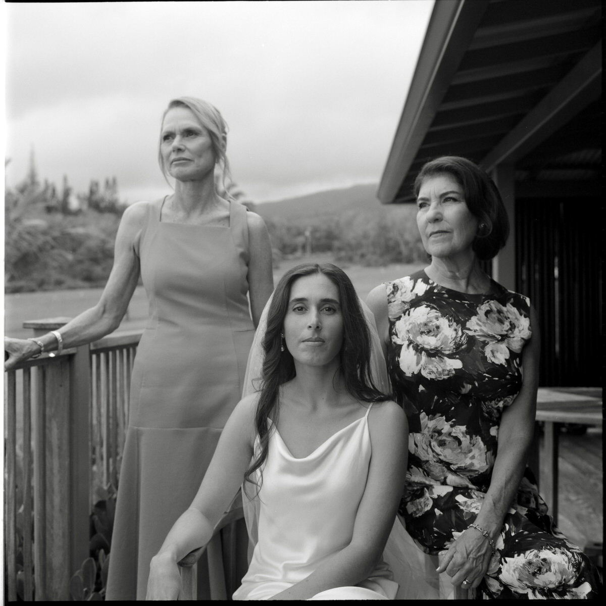 medium format photo of bride and her family posing classically outside their hotel room in Maui