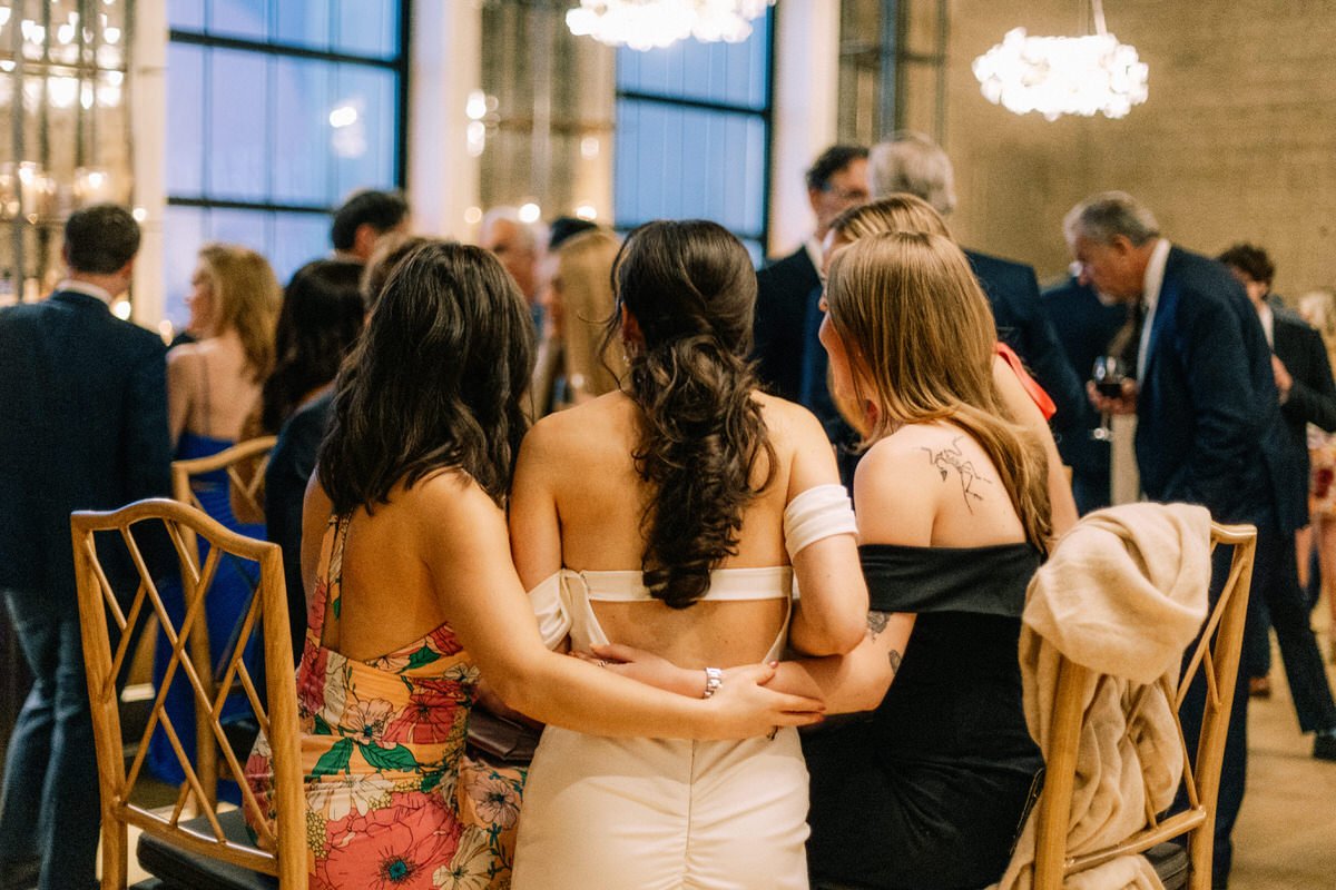 bride being hugged by two of her closest friends during cocktail hour at the Switch House by Cescaphe