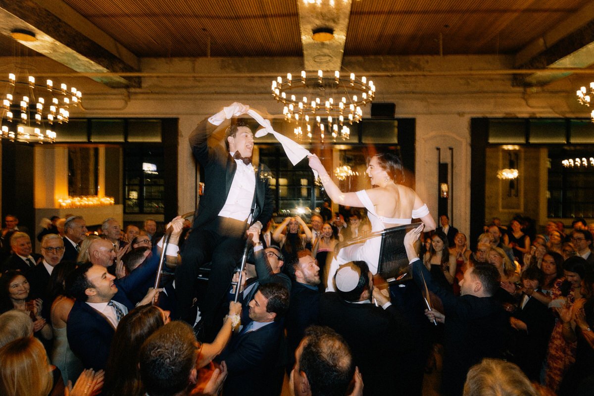 Jewish wedding couple during the hora at the Switch House by Cescaphe