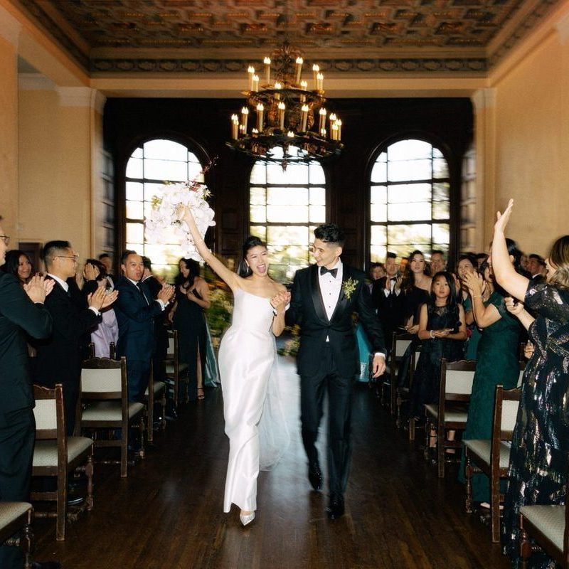beautiful korean couple walking down the aisle as newlyweds after their wedding ceremony at the ebell of los angeles