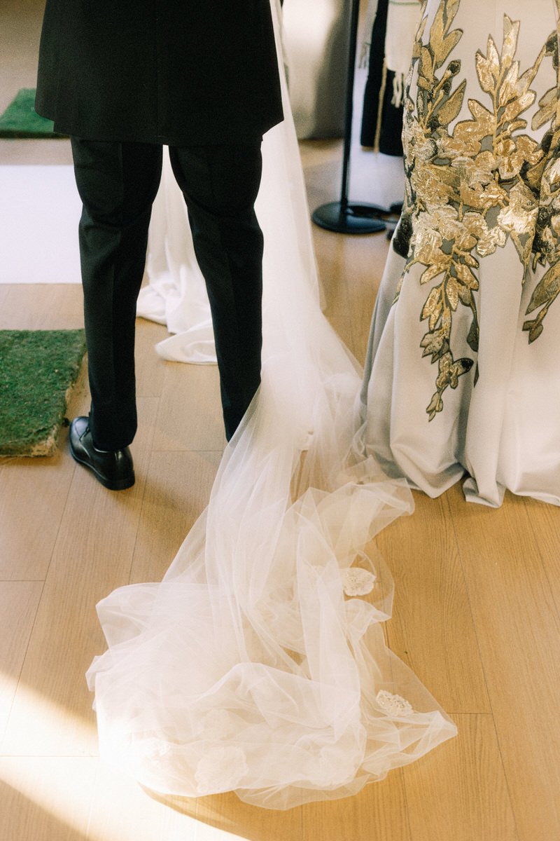 detail of wedding veil covering groom's foot at a marriage ceremony in Philadelphia