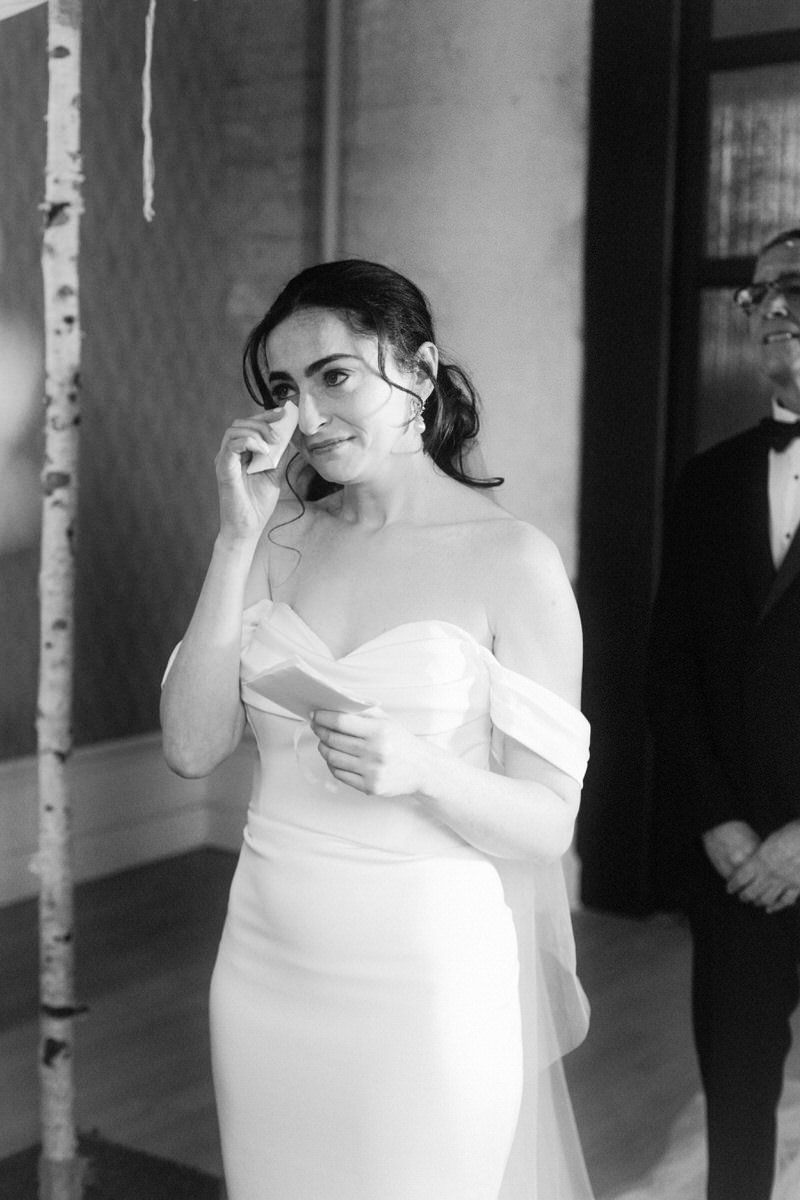 bride wiping away tears as she reads her vows to the groom at the Switch House by Cescaphe