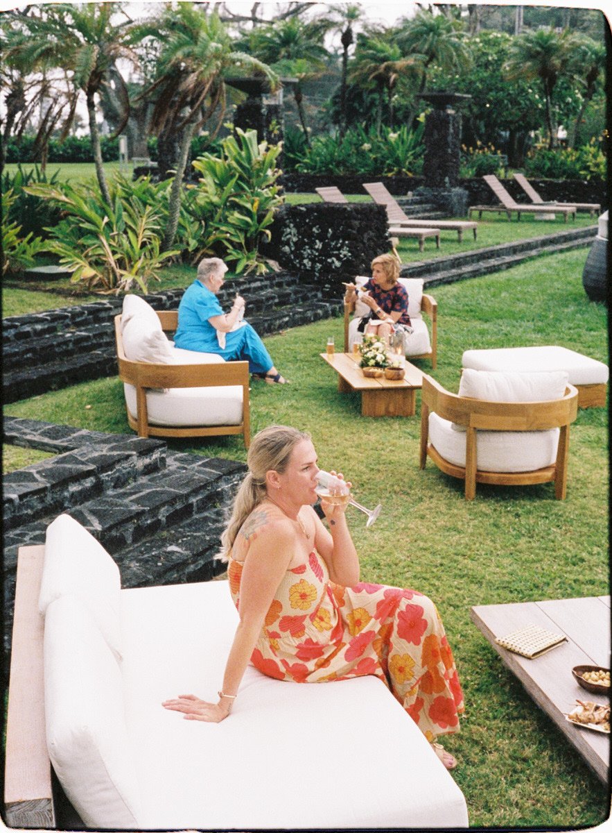 35mm film photo of wedding guests lounging on sofas at a resort in Maui