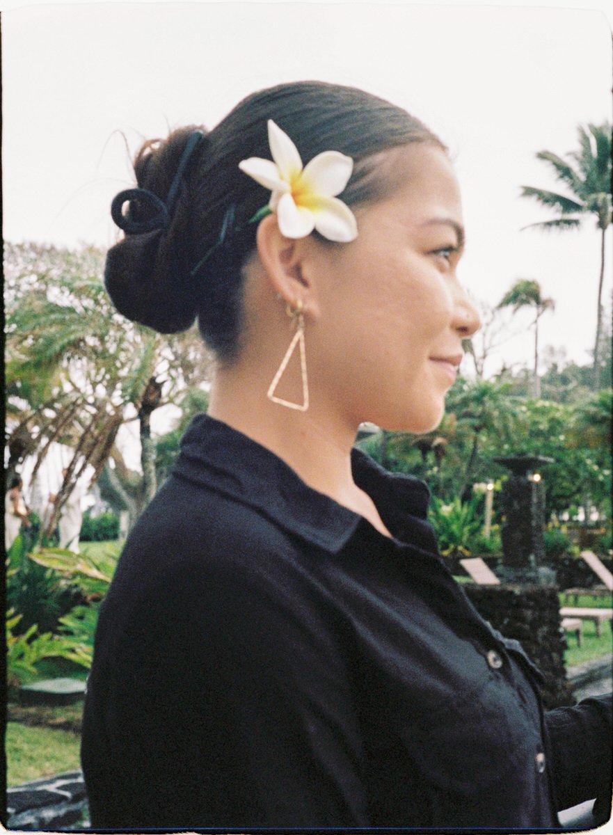 35mm film photo of wedding guest with a tropical flower in her hair
