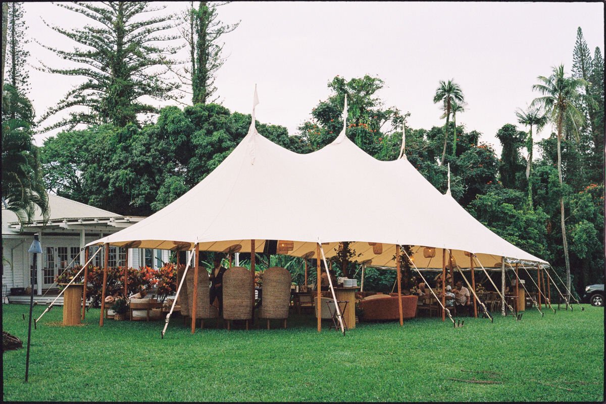 35mm film photo of a beautiful tented reception with rattan details for a Maui wedding