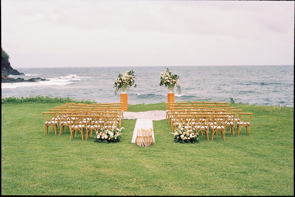 35mm film photo of a gorgeous wedding ceremony location on a lawn with a view of the water in Maui