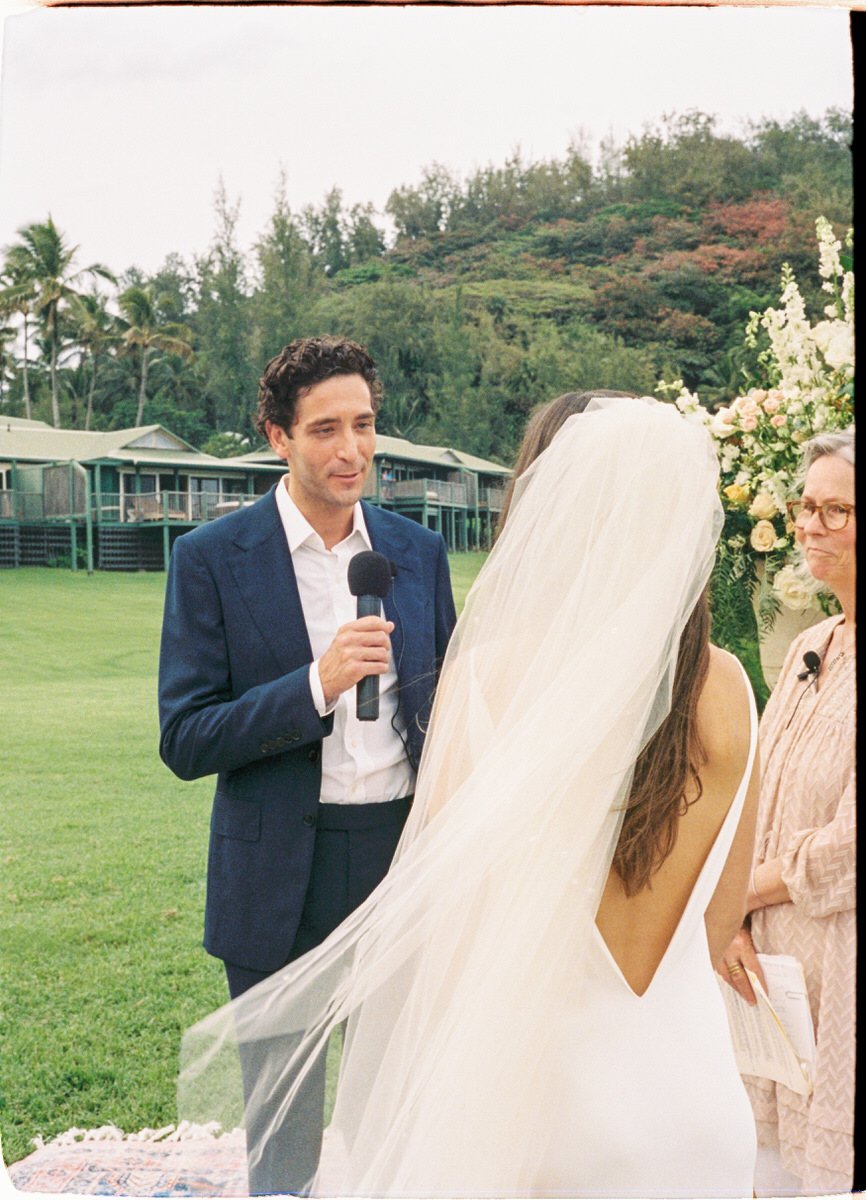 35mm film photo of groom speaking to bride during their wedding ceremony in Hawaii