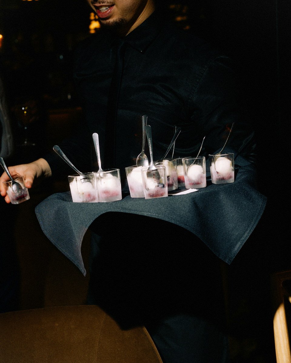 Cescaphe Group server carrying a tray of mini sorbet cups during a wedding reception at the Switch House by Cescaphe