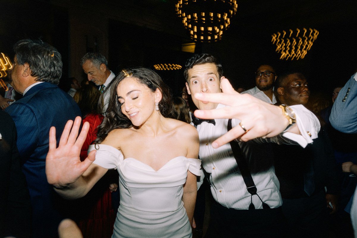 fun spontaneous photo of bride and groom interacting with the photographer at their wedding in Philadelphia