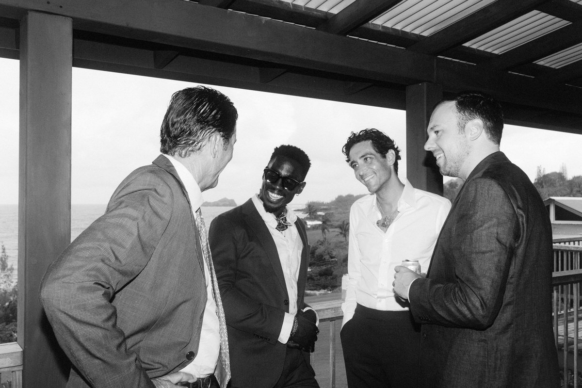 groom enjoying the company of his friends during his wedding day prep in Maui