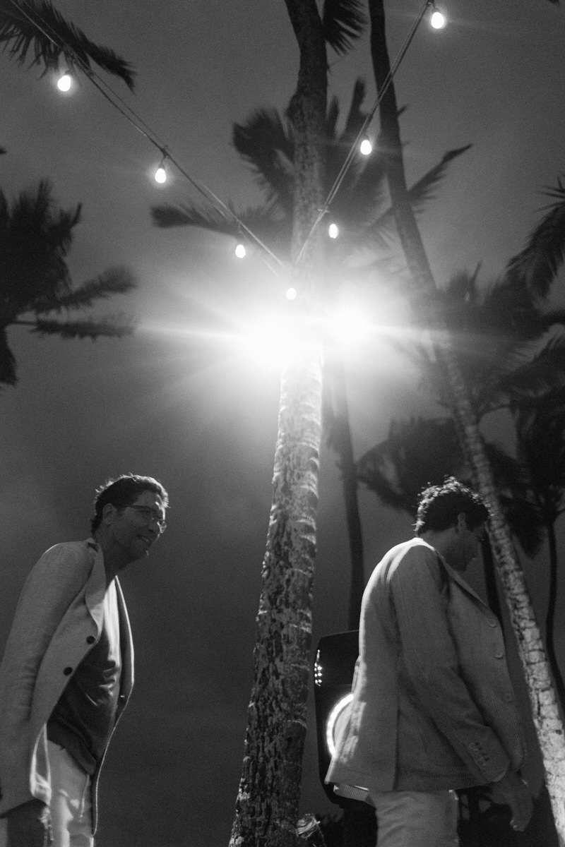 low down perspective of wedding guests and palm trees in Hawaii