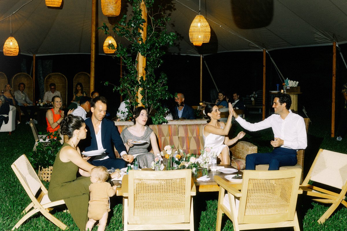 bride and groom high fiving during their wedding reception in Maui