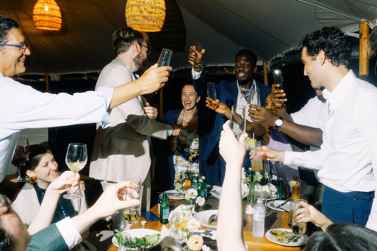 happy guests toasting with the groom during a wedding reception in Hawaii
