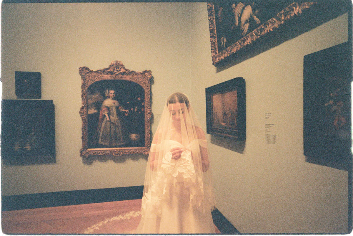 romantic portrait of a bride wearing a floral veil at the AGO captured on 35mm film
