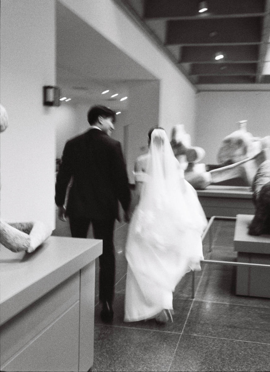 artistic blurry photo of wedding couple walking through the AGO Henry Moore Sculpture Centre