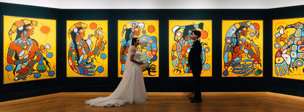 wedding couple posing in front of Indigenous artwork Man Changing Into Thunderbird at the AGO Art Gallery of Ontario